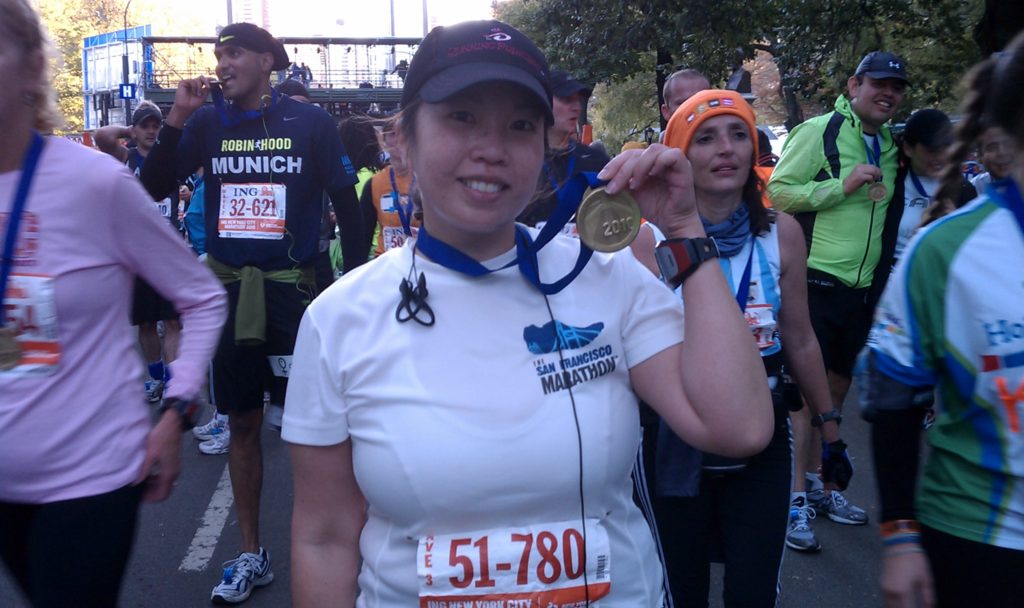 NYC marathon runner holding her medal